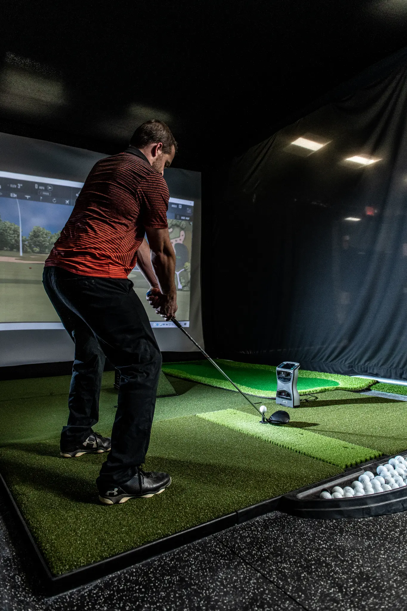 Golfer swinging at Precision Golf Training indoor simulator in Libertyville IL — Foresight GCQuad launch monitor